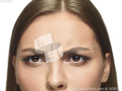 Image of Close up portrait of beautiful young woman face on white studio background