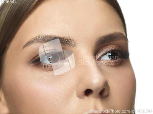 Image of Close up portrait of beautiful young woman face on white studio background