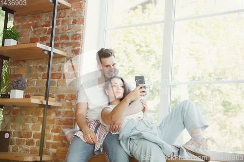 Image of Young couple moved to a new house or apartment