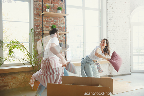 Image of Young couple moved to a new house or apartment