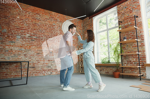 Image of Young couple moved to a new house or apartment