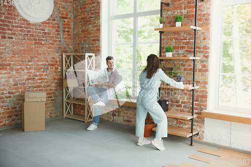 Image of Young couple moved to a new house or apartment