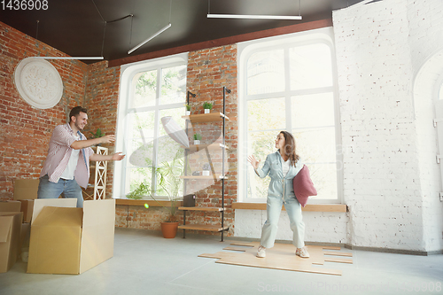 Image of Young couple moved to a new house or apartment