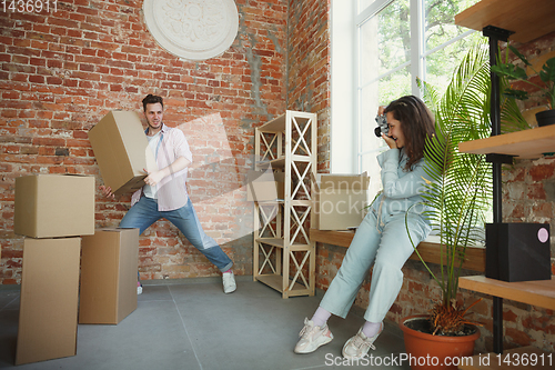 Image of Young couple moved to a new house or apartment