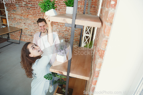 Image of Young couple moved to a new house or apartment