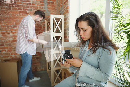 Image of Young couple moved to a new house or apartment