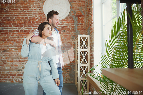 Image of Young couple moved to a new house or apartment