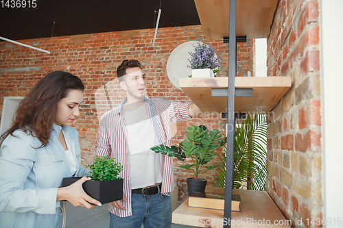 Image of Young couple moved to a new house or apartment