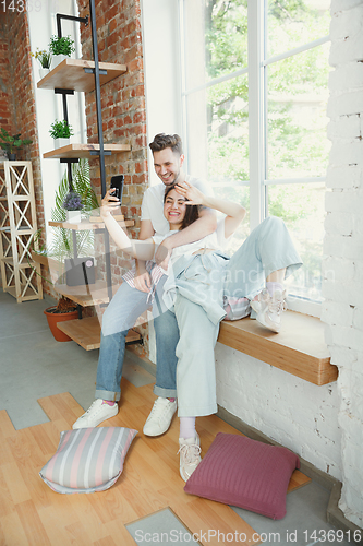 Image of Young couple moved to a new house or apartment