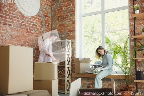 Image of Young couple moved to a new house or apartment