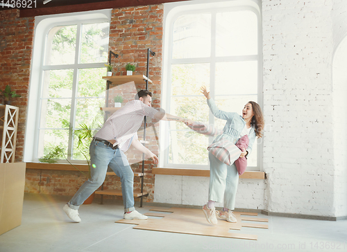 Image of Young couple moved to a new house or apartment