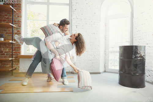 Image of Young couple moved to a new house or apartment