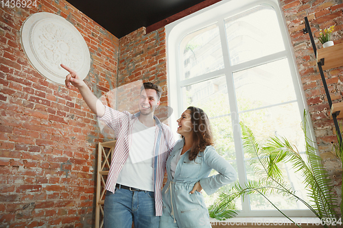 Image of Young couple moved to a new house or apartment