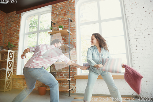 Image of Young couple moved to a new house or apartment