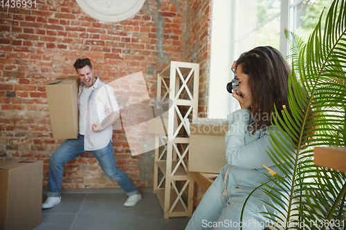 Image of Young couple moved to a new house or apartment