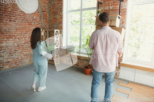 Image of Young couple moved to a new house or apartment