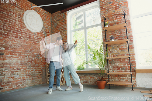 Image of Young couple moved to a new house or apartment