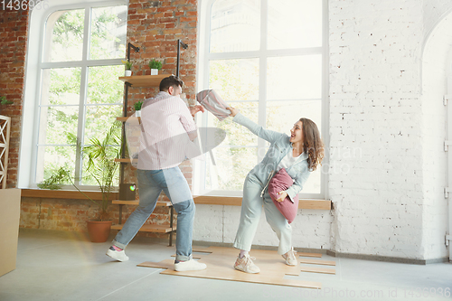 Image of Young couple moved to a new house or apartment