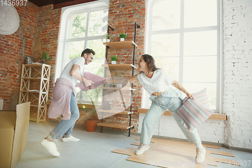 Image of Young couple moved to a new house or apartment