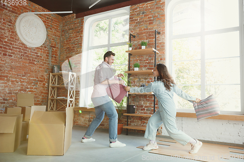 Image of Young couple moved to a new house or apartment