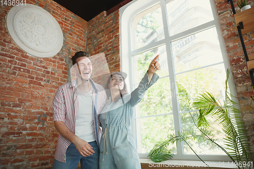 Image of Young couple moved to a new house or apartment