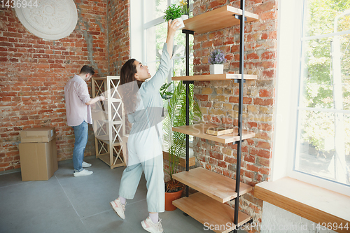 Image of Young couple moved to a new house or apartment