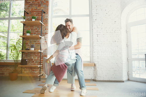 Image of Young couple moved to a new house or apartment