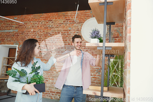 Image of Young couple moved to a new house or apartment