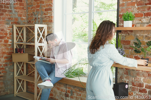 Image of Young couple moved to a new house or apartment