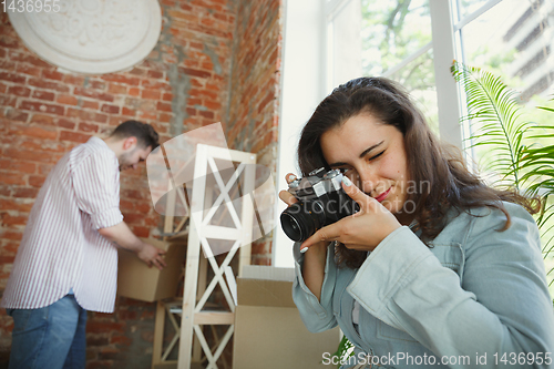 Image of Young couple moved to a new house or apartment