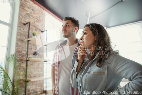 Image of Young couple moved to a new house or apartment