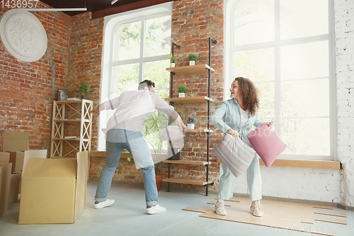 Image of Young couple moved to a new house or apartment