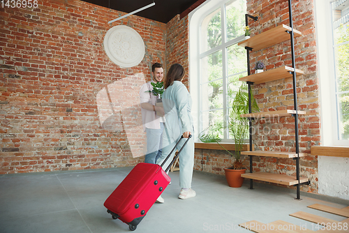 Image of Young couple moved to a new house or apartment