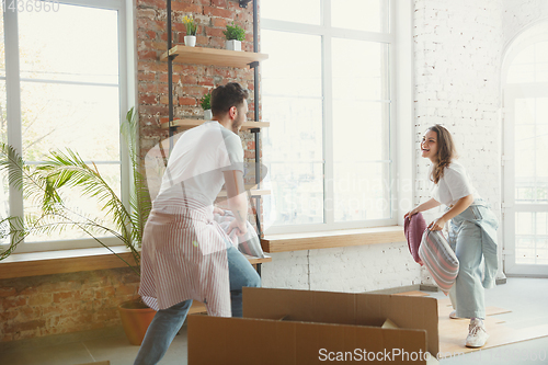 Image of Young couple moved to a new house or apartment