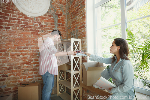 Image of Young couple moved to a new house or apartment