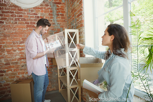 Image of Young couple moved to a new house or apartment