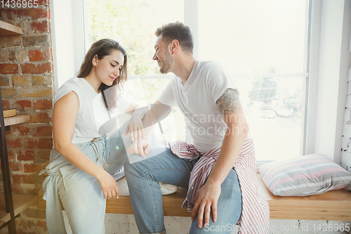 Image of Young couple moved to a new house or apartment