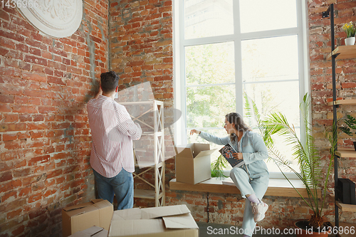 Image of Young couple moved to a new house or apartment