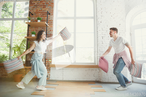 Image of Young couple moved to a new house or apartment