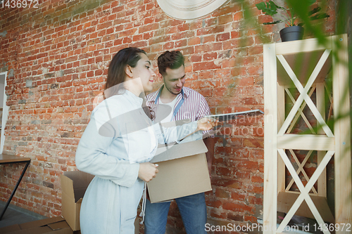 Image of Young couple moved to a new house or apartment