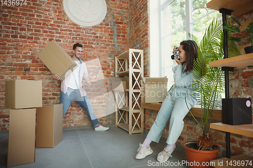 Image of Young couple moved to a new house or apartment