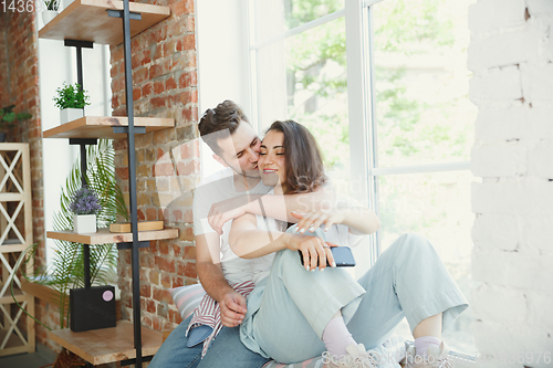 Image of Young couple moved to a new house or apartment