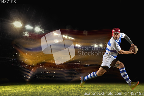 Image of One caucasian man playing rugby on the stadium in mixed light