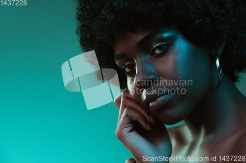 Image of Portrait of female high fashion model in neon light