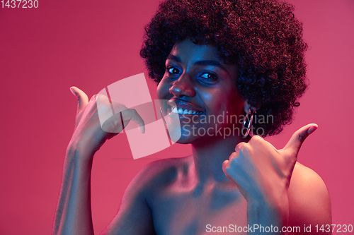 Image of Portrait of female high fashion model in neon light