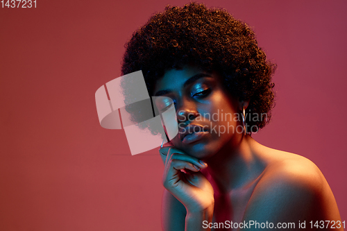 Image of Portrait of female high fashion model in neon light