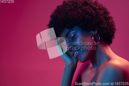 Image of Portrait of female high fashion model in neon light