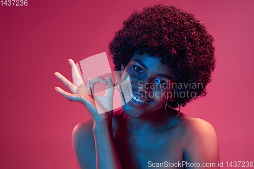 Image of Portrait of female high fashion model in neon light