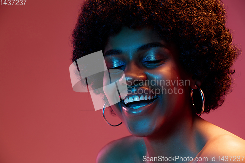 Image of Portrait of female high fashion model in neon light