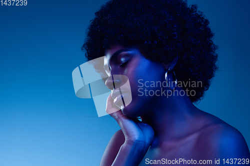 Image of Portrait of female high fashion model in neon light